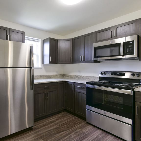 Thumbnail 7 of 12 End kitchen with a window and pantry at Dodson Pointe Apartment Homes, Rogers, AR