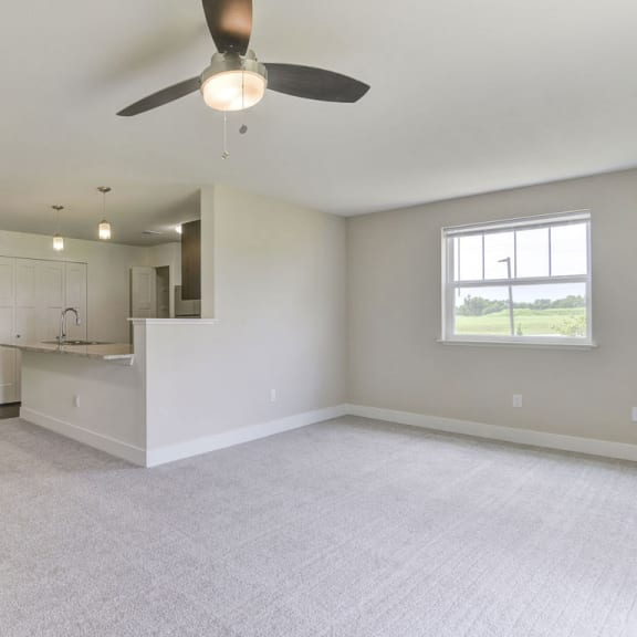 Thumbnail 6 of 12 An enlarged living room with plush carpeting at Dodson Pointe Apartment Homes, Arkansas