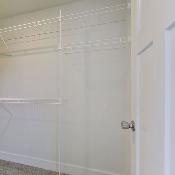 Thumbnail 11 of 13 A walk in closet with wardrobe organizers at Dodson Pointe Apartment Homes, Arkansas, 72758