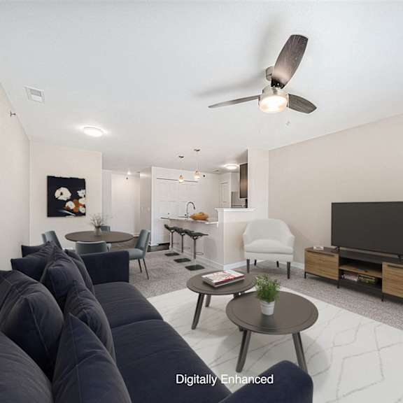 Thumbnail 5 of 14 A living room with a sofa and a ceiling fan at Dodson Pointe Apartment Homes, Rogers