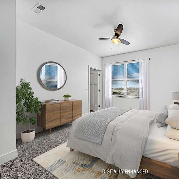 Thumbnail 10 of 13 A bedroom with a bed, a ceiling fan, and a window with blinds at Dodson Pointe Apartment Homes, Rogers
