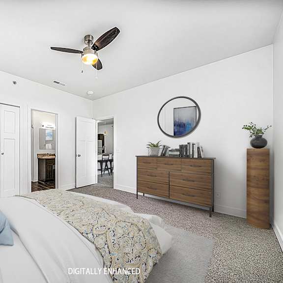 Thumbnail 12 of 13 A bedroom with a bed, dresser, ceiling fan and an ensuite at Dodson Pointe Apartment Homes, Rogers