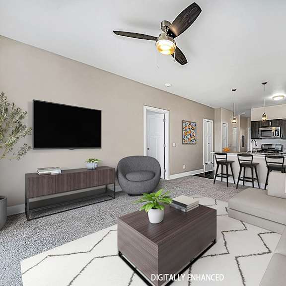 Thumbnail 6 of 13 A living room with a grey armchair, a white sofa, a wooden coffee table at Dodson Pointe Apartment Homes, Rogers