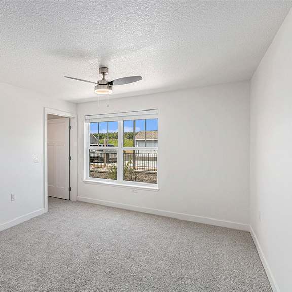 Thumbnail 13 of 18 Bedroom with plush carpeting and large window at Eagle Ridge Apartment Homes, Traverse City, 49685