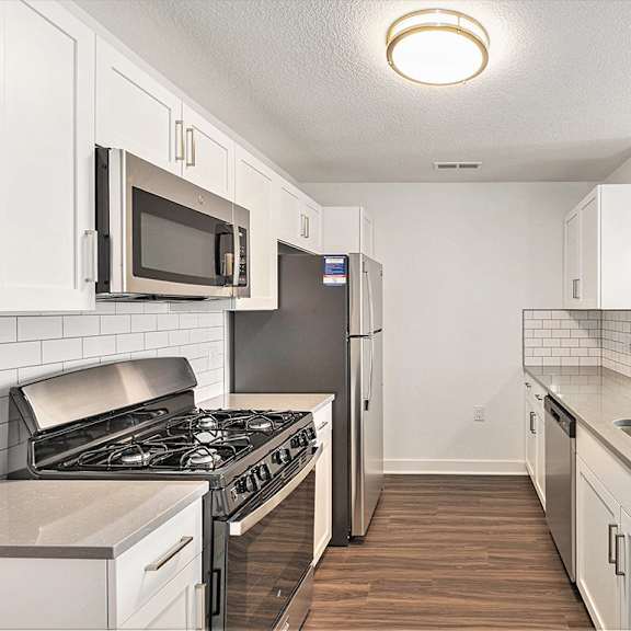 Thumbnail 9 of 18 A kitchen with a white shaker-style cabinets at Eagle Ridge Apartment Homes, Traverse City, MI 49685