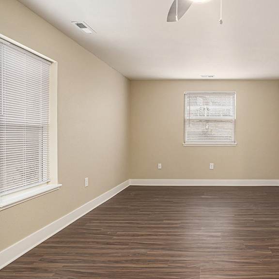 Thumbnail 8 of 15 A living room with hard surface flooring and a window at Eagle Ridge Apartment Homes,  Michigan 49685