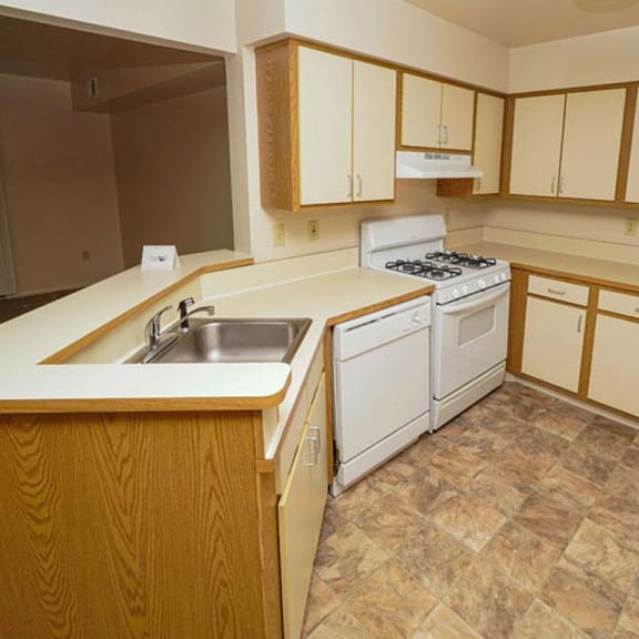 Thumbnail 7 of 10 A kitchen with a breakfast bar at Emerald Park Apartments, Michigan, 49001