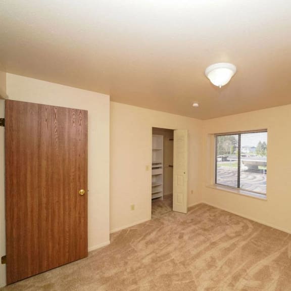 Thumbnail 10 of 10 A bedroom with a closet with organizers at Emerald Park Apartments, Michigan