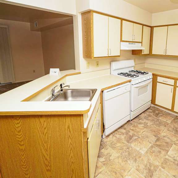 Thumbnail 4 of 7 A kitchen with a breakfast bar at Emerald Park Apartments, Michigan, 49001