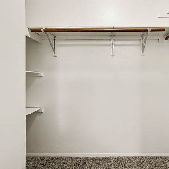 Thumbnail 17 of 17 A walk-in closet with shelving at Emerald Park Apartments, Kalamazoo, Michigan