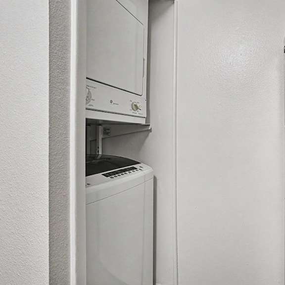 Thumbnail 8 of 17 A washer and dryer in a kitchen at Emerald Park Apartments, Kalamazoo, Michigan