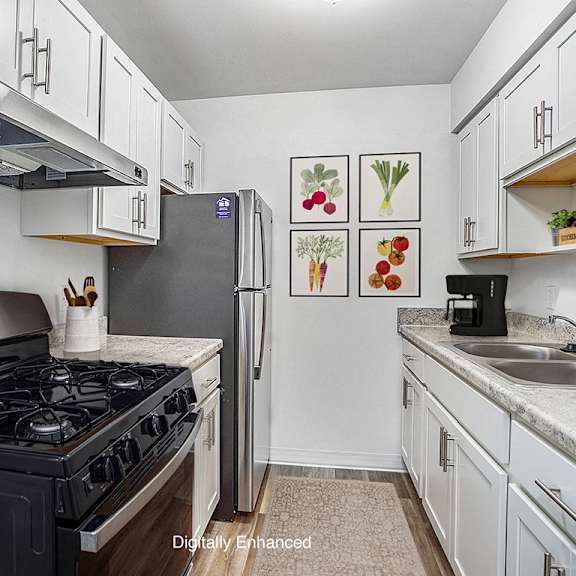 Thumbnail 9 of 17 a kitchen with stainless steel appliances at Fairlane Apartments in MI 49037