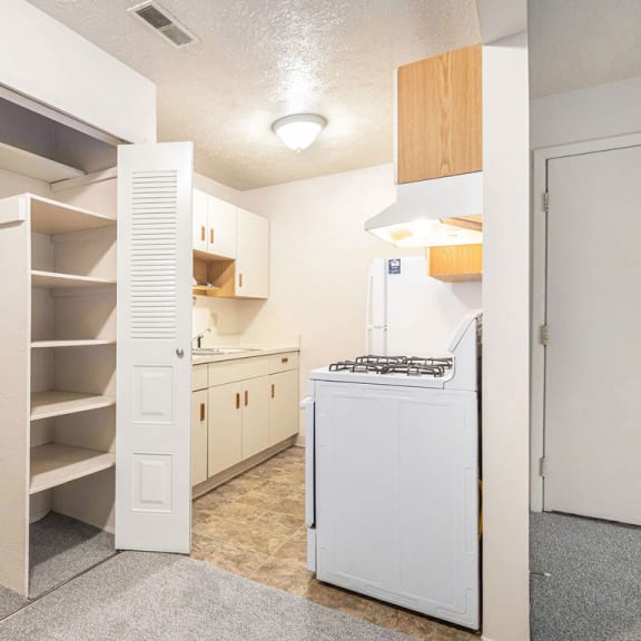 Thumbnail 9 of 13 a kitchen with white cabinets and a white refrigerator at Old Farm Apartments, Elkhart, 46517