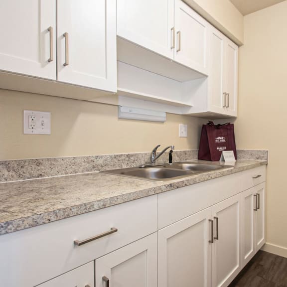 Thumbnail 6 of 13 an upgraded kitchen with white cabinets and a refrigerator at Old Farm Apartments, Elkhart, 46517