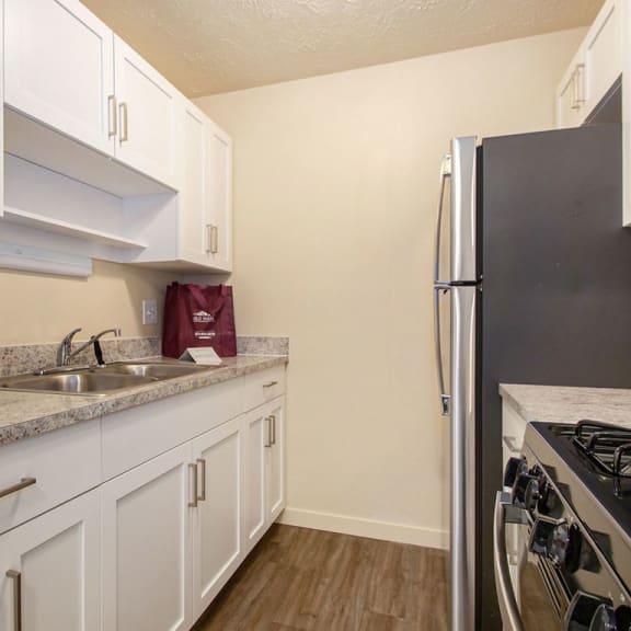 Thumbnail 5 of 13 a kitchen with white cabinets and a stainless steel refrigerator at Old Farm Apartments, Elkhart, IN, 46517