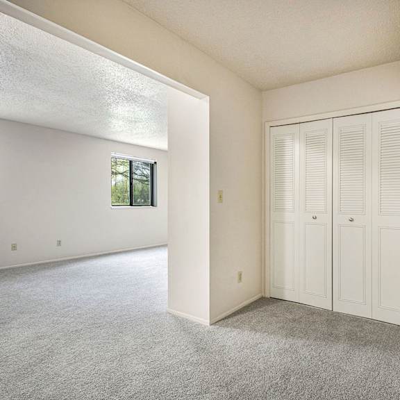 Thumbnail 12 of 12 A sleeping area with white walls and a grey carpet at Old Farm Apartments, Elkhart, 46517