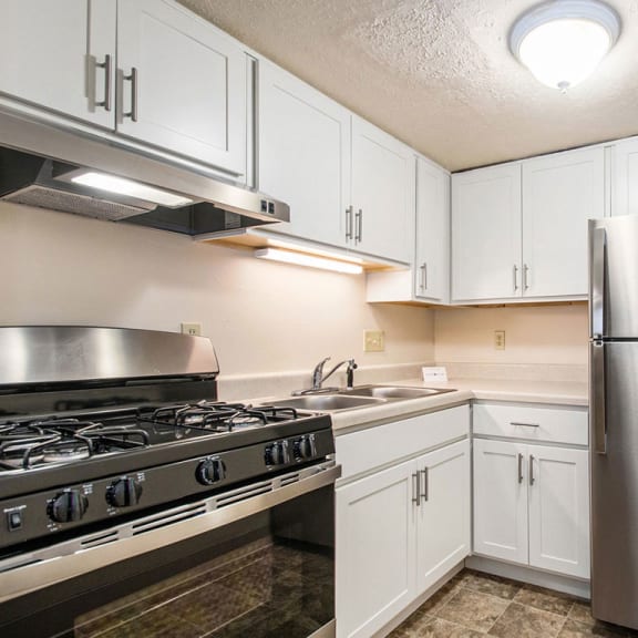 Thumbnail 7 of 12 a kitchen with stainless steel appliances and white cabinets at Old Farm Apartments, Elkhart, 46517