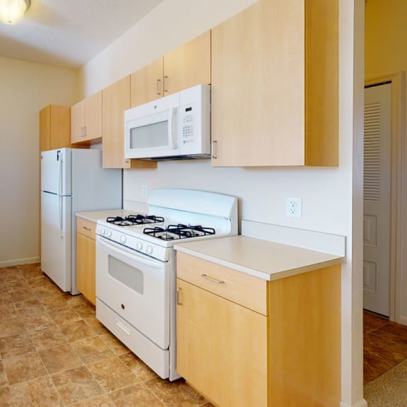 Thumbnail 5 of 12 a two bedroom kitchen with white appliances at Fieldstream Apartment Homes in Ankeny, IA