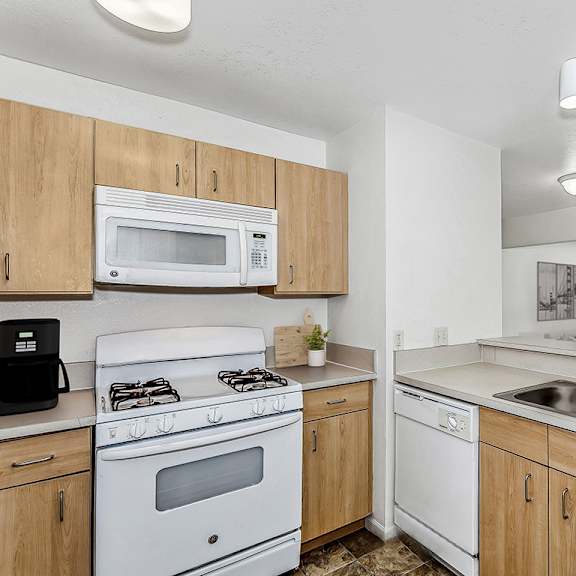 Thumbnail 8 of 18 a kitchen with a stove microwave and dishwasher at Fieldstream Apartment Homes in Ankeny, IA