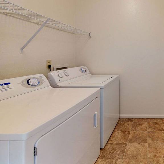 Thumbnail 7 of 12 a washer and dryer in a laundry room with a door at Fieldstream Apartment Homes in Ankeny, IA