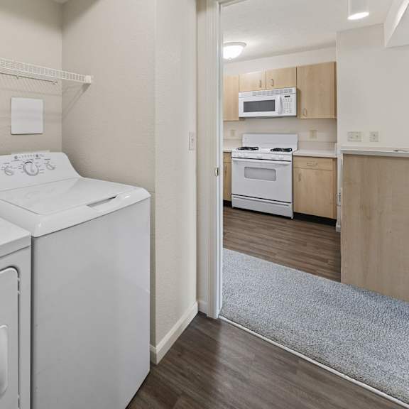 Thumbnail 10 of 18 A laundry room with a washer and dryer at Fieldstream Apartment Homes, Iowa