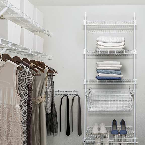 Thumbnail 14 of 18 A white closet with clothes and shoes on shelves at Fieldstream Apartment Homes in Ankeny, IA