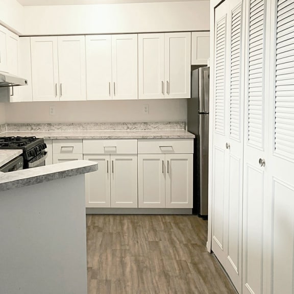 Thumbnail 7 of 8 a kitchen with white cabinets and stainless steel appliances at Foxwood and The Hermitage, Portage