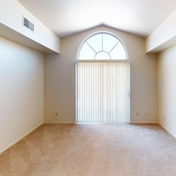 Thumbnail 5 of 8 A living room with a large window and a cathedral ceiling at Foxwood and The Hermitage, Portage