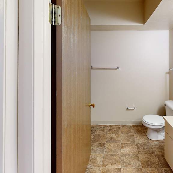 Thumbnail 7 of 13 A bathroom with a toilet, sink, and a bathtub at Foxwood and The Hermitage, Portage, MI, 49024