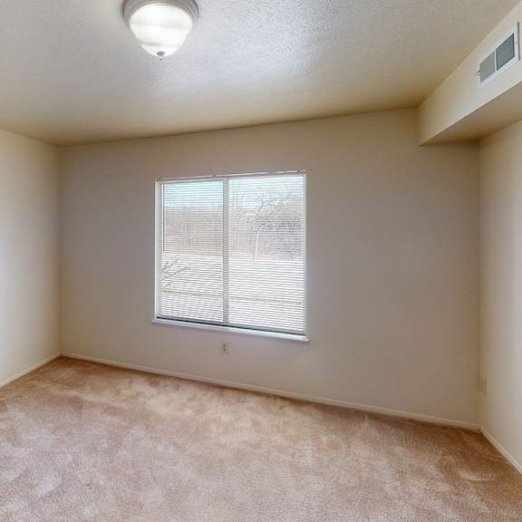 Thumbnail 10 of 12 A bedroom with a large window and plush carpet at Foxwood and The Hermitage, Portage