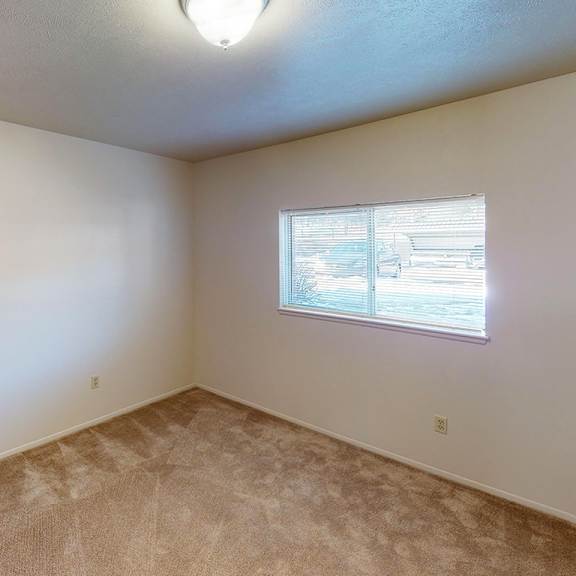 Thumbnail 7 of 12 A bedroom with a window and carpet at Foxwood and The Hermitage, Portage