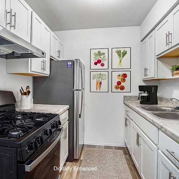 Thumbnail 8 of 14 An upgraded kitchen with white cabinets at Glen Oaks Apartments, Michigan, 49442