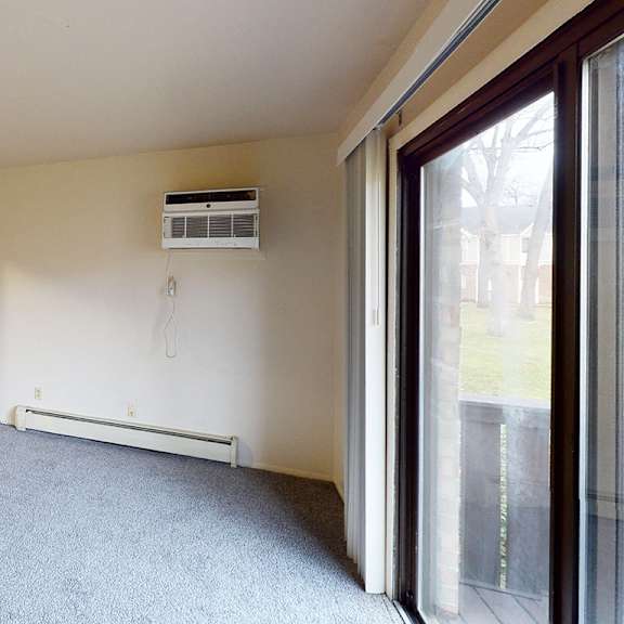 Thumbnail 6 of 14 A living room leading to the kitchen at Glen Oaks Apartments, Michigan, 49442