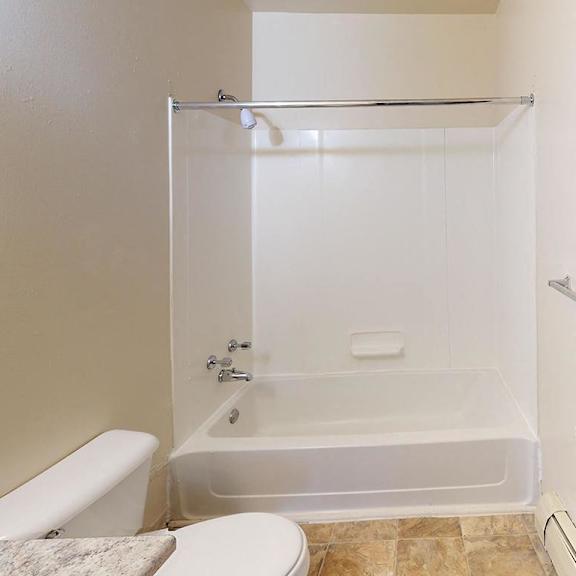 Thumbnail 11 of 12 A bathroom with a bathtub/shower combination at Glen Oaks Apartments, Michigan, 49442