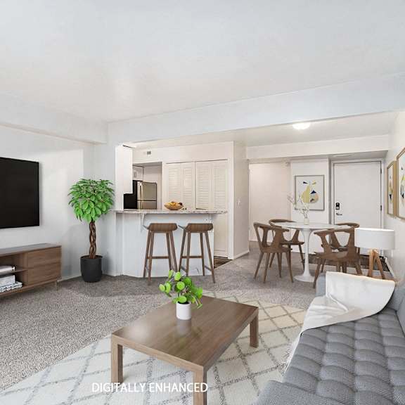 Thumbnail 7 of 16 the living room and kitchen of an upgraded apartment at Glenn Valley Apartments in Battle Creek, MI