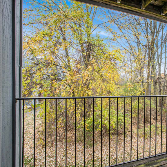 Thumbnail 6 of 16 a private balcony with a view of trees at Glenn Valley Apartments in Battle Creek, MI