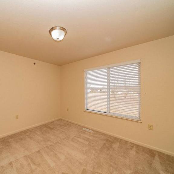Thumbnail 8 of 11 an empty room with a door and a window at Gull Prairie/Gull Run Apartments and Townhomes, Michigan, 49048