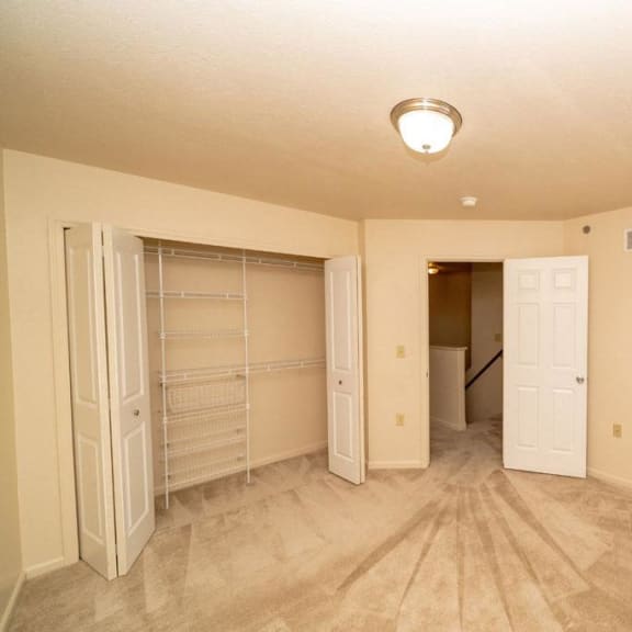 Thumbnail 9 of 11 an empty bedroom with a closet and a door to a bathroom at Gull Prairie/Gull Run Apartments and Townhomes, Kalamazoo, MI, 49048