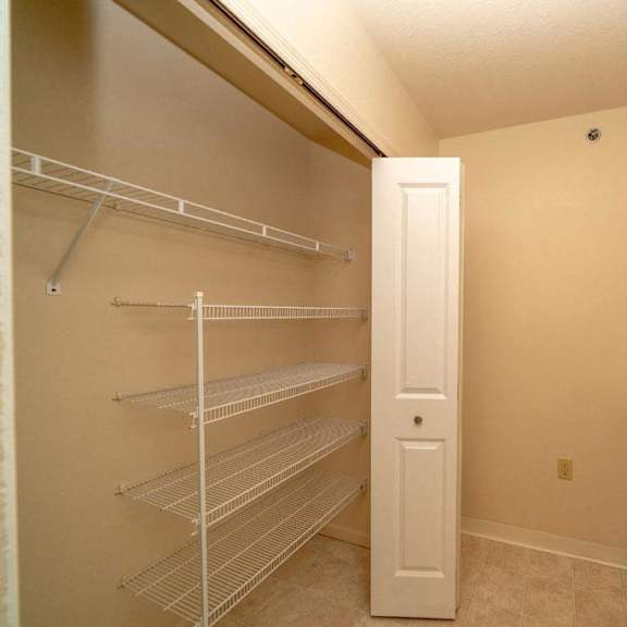 Thumbnail 6 of 11 a laundry room with a closet and a washer and dryer