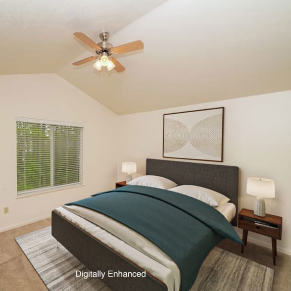Thumbnail 9 of 14 a bedroom with a vaulted ceiling and fan at Gull Prairie/Gull Run Apartments and Townhomes, Michigan, 49048