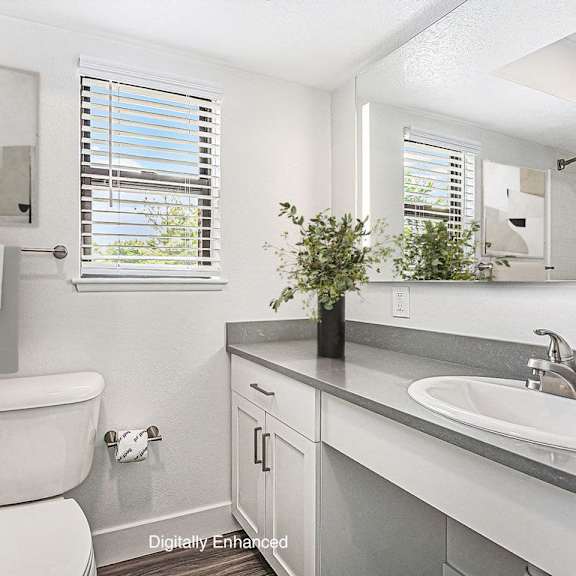 Thumbnail 8 of 10 a bathroom with a toilet and a window at Green Ridge Apartments, Grand Rapids, MI