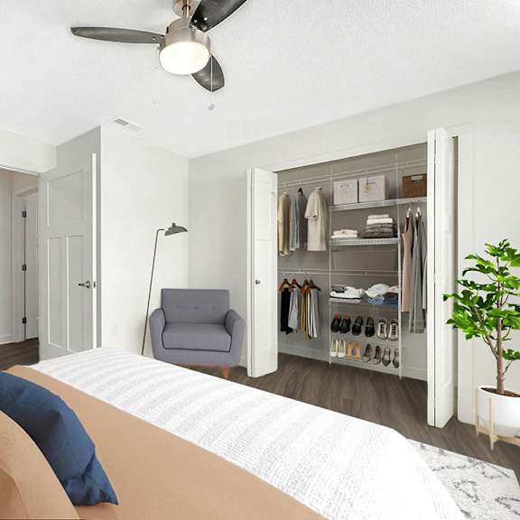 Thumbnail 16 of 19 Bedroom with walk-in closet and ceiling fan at The Grove Apartment Homes, Nebraska