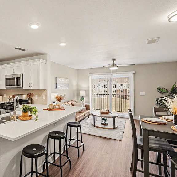 Thumbnail 3 of 19 A kitchen with white cabinets and a stainless steel refrigerator at The Grove Apartment Homes, Nebraska
