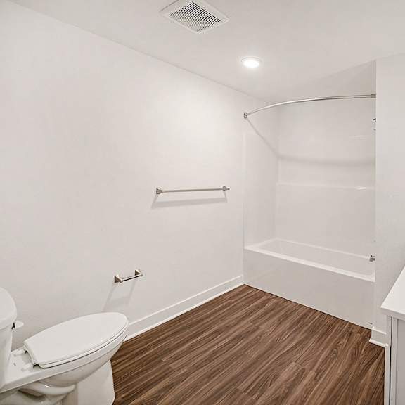 Thumbnail 9 of 14 A white bathroom with hard-surface flooring at The Grove Apartment Homes in Lincoln, NE