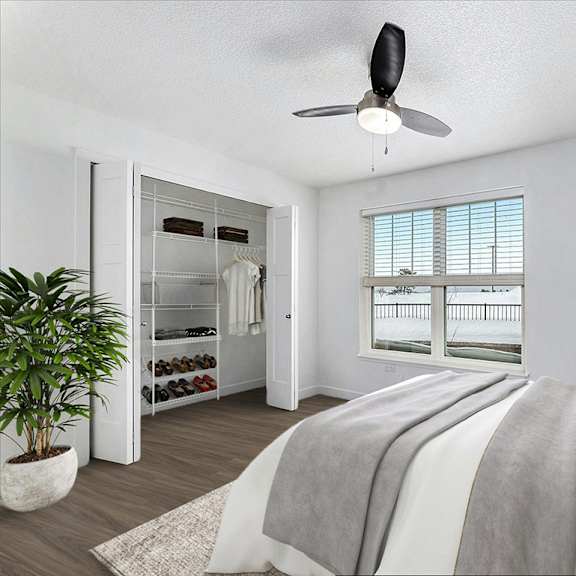 Thumbnail 10 of 14 Bedroom with expansive window, ceiling fan and walk-in closet at The Grove Apartment Homes, Lincoln, NE 68512