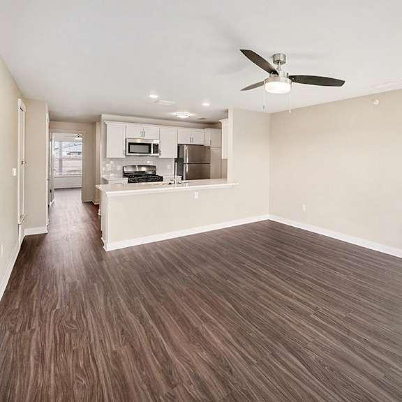 Thumbnail 5 of 14 A dining room with a ceiling fan and breakfast bar at The Grove Apartment Homes in Lincoln, NE