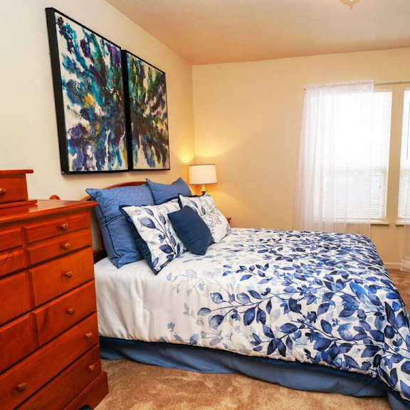 Thumbnail 8 of 12 a bedroom with a large window at Gull Prairie/Gull Run Apartments and Townhomes, Kalamazoo, MI, 49048
