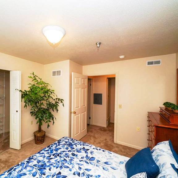 Thumbnail 6 of 6 a bedroom with a large bed and a closet at Gull Prairie/Gull Run Apartments and Townhomes, Kalamazoo, MI