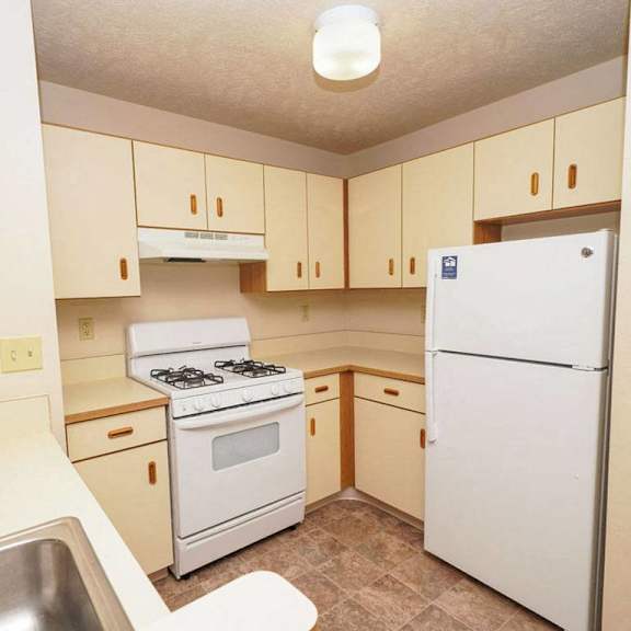 Thumbnail 5 of 12 a kitchen with white appliances at Gull Prairie/Gull Run Apartments and Townhomes, Michigan, 49048