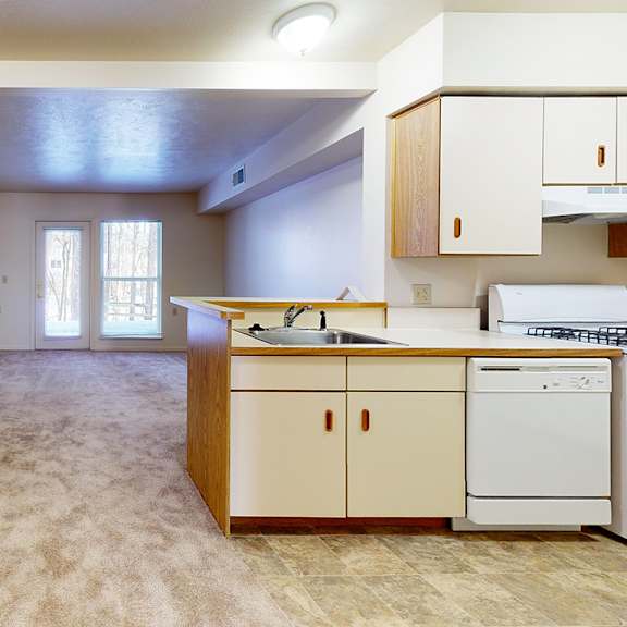 Thumbnail 6 of 13 A kitchen with a sink, stove, and dishwasher at Gull Prairie/Gull Run Apartments and Townhomes in Kalamazoo, MI